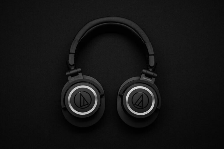 Black wireless headset on a black background demonstrating how do wireless headphones work.