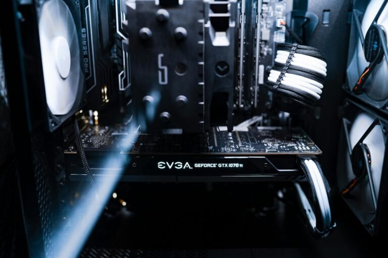 Inside view of a gaming PC with white LED lighting, showcasing the components and wiring. Is it cheaper to build or buy a gaming PC?