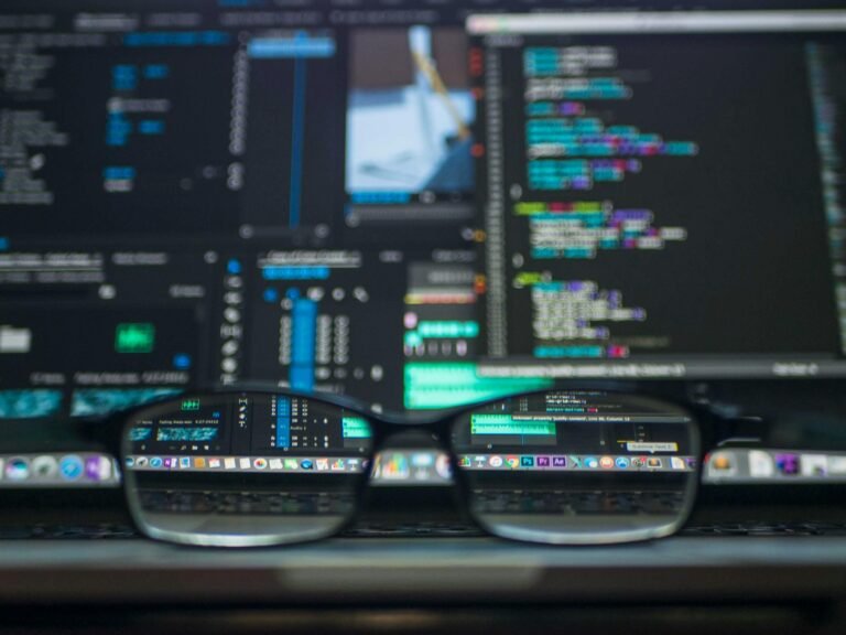 Computer monitor displaying lines of programming code in a dark-themed text editor