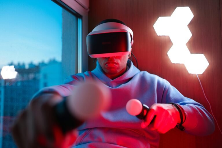 Man wearing a VR headset in a room with LED lighting, showcasing the immersive experience of virtual reality, highlighting the advancements in VR headset technology.